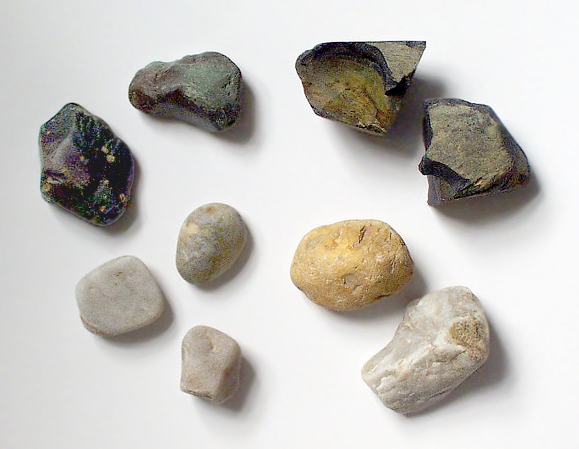 9 stones ranging from white to grey to beige to black on a white background
