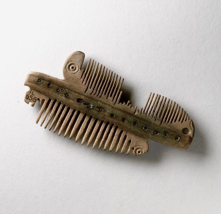 double-sided antler comb. Some prongs are broken, but it is otherwise in good condition
