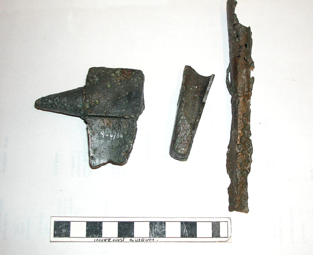 A bronze anvil, a bronze socketed hammerhead and a part of a bronze spearhead.