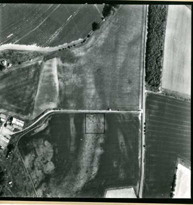 Black and white aerial photograph of field systems with visible cropmarks. A pit alignment is highlighted with a black square. 