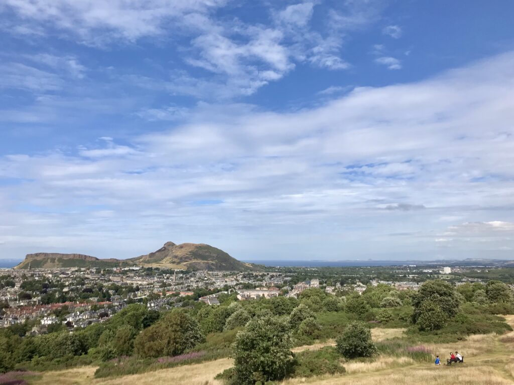 Landscape view of Arthur's seat, with rows of housing in the foreground