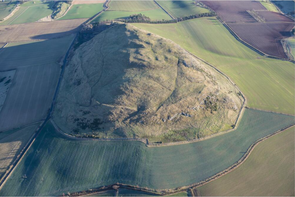Aerial photograph of a mound surrounded by fields