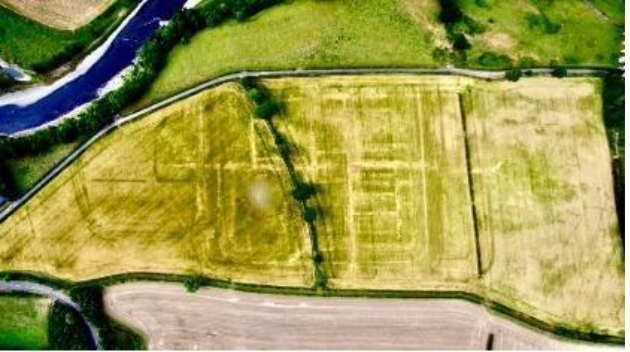 Aerial image of crop marks in grass outlining the rectangular fort