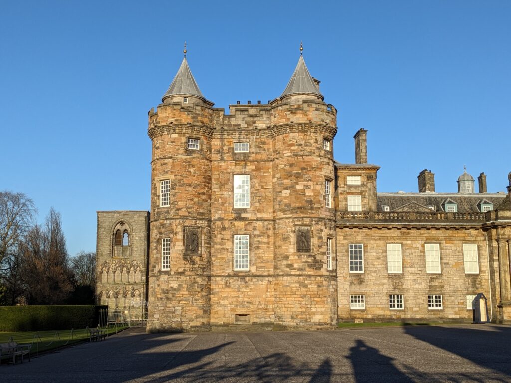 Front facade of Holyrood Palace, with ruins of Holyrood Abbey to the left