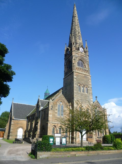 Photograph of church with spire from street view
