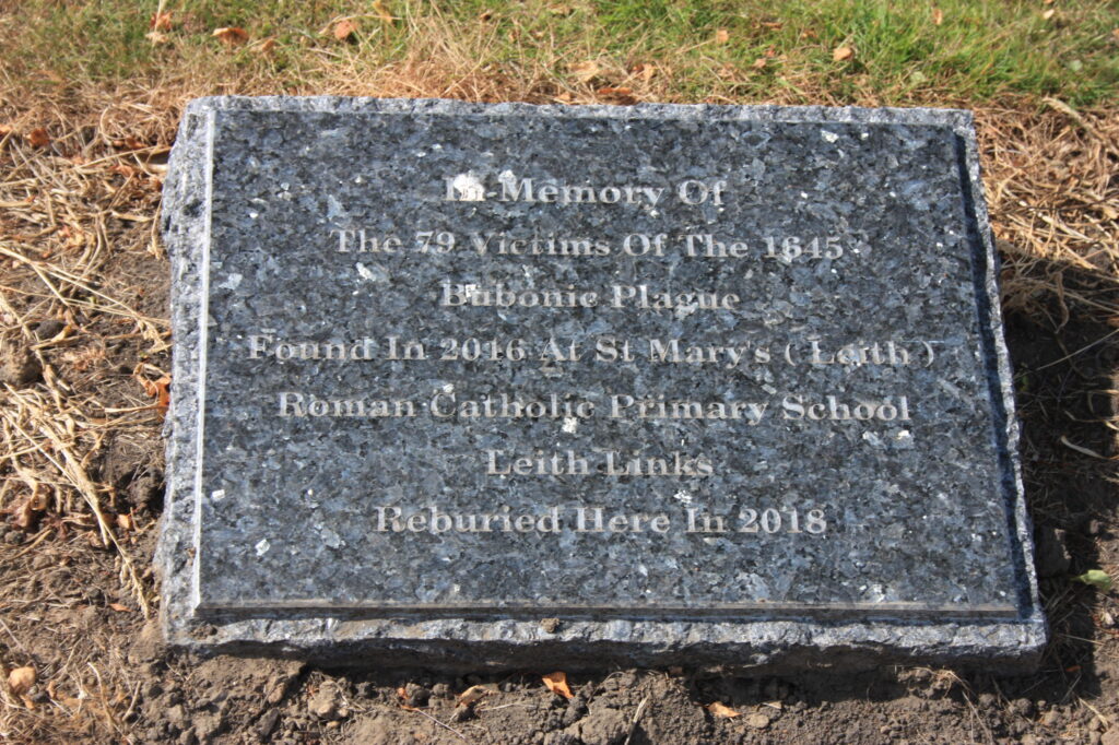 Photograph of burial plaque with engraving