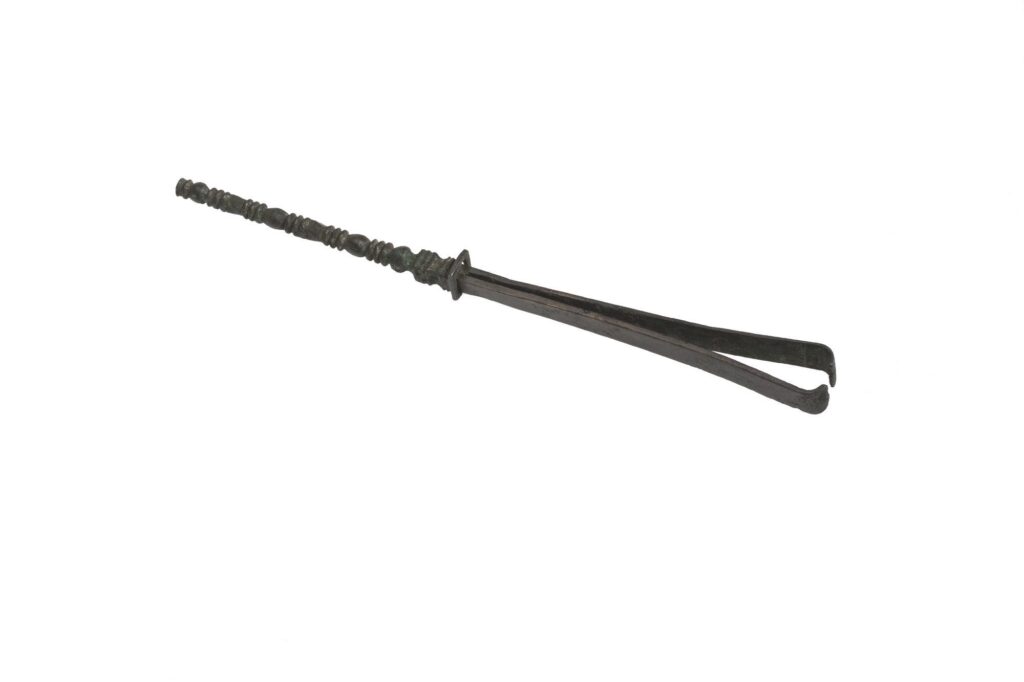 Photograph of metal forceps on white background