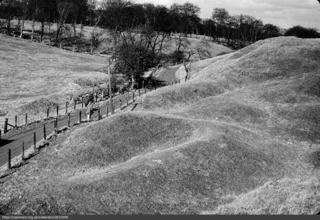 Black and white image of lime clamps with road