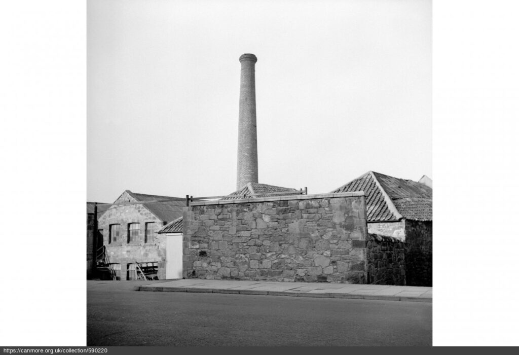 Black and white photograph of building with tower from street