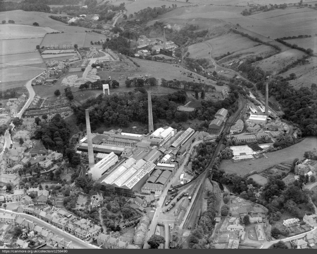 Black and white aerial image of paper mills surrounded by village and fields