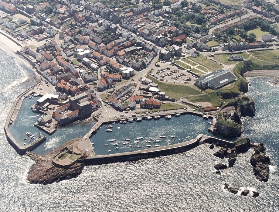 aerial view of harbour and battery with sea in front and housing behind