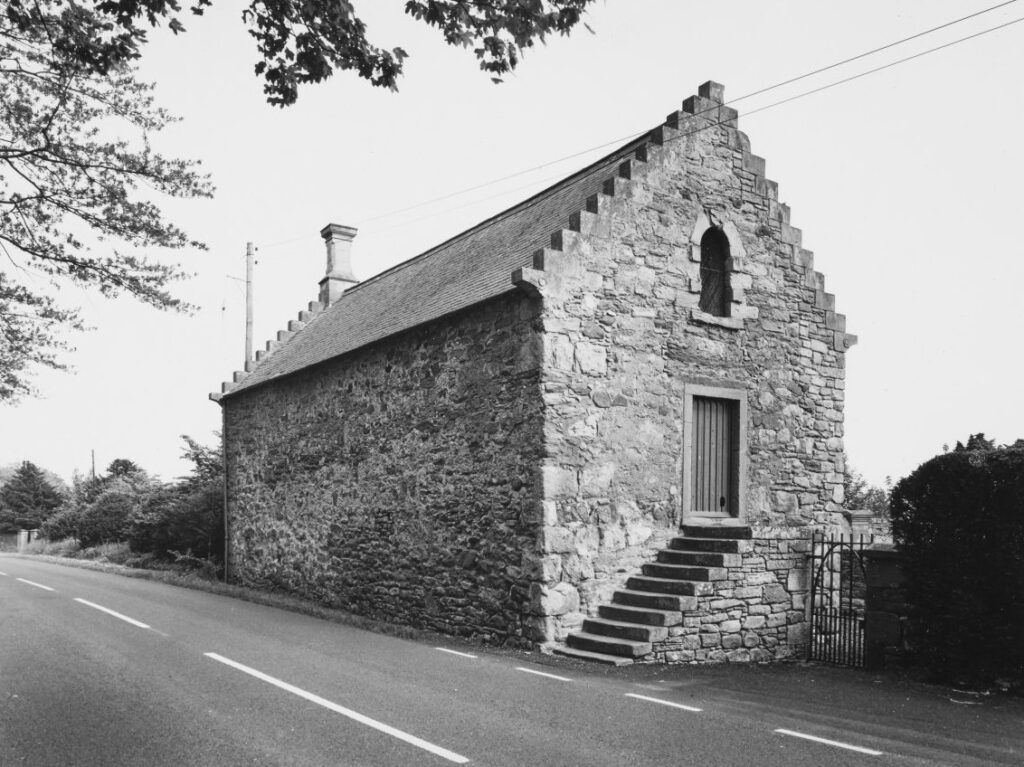 brick rectangular building on edge of road