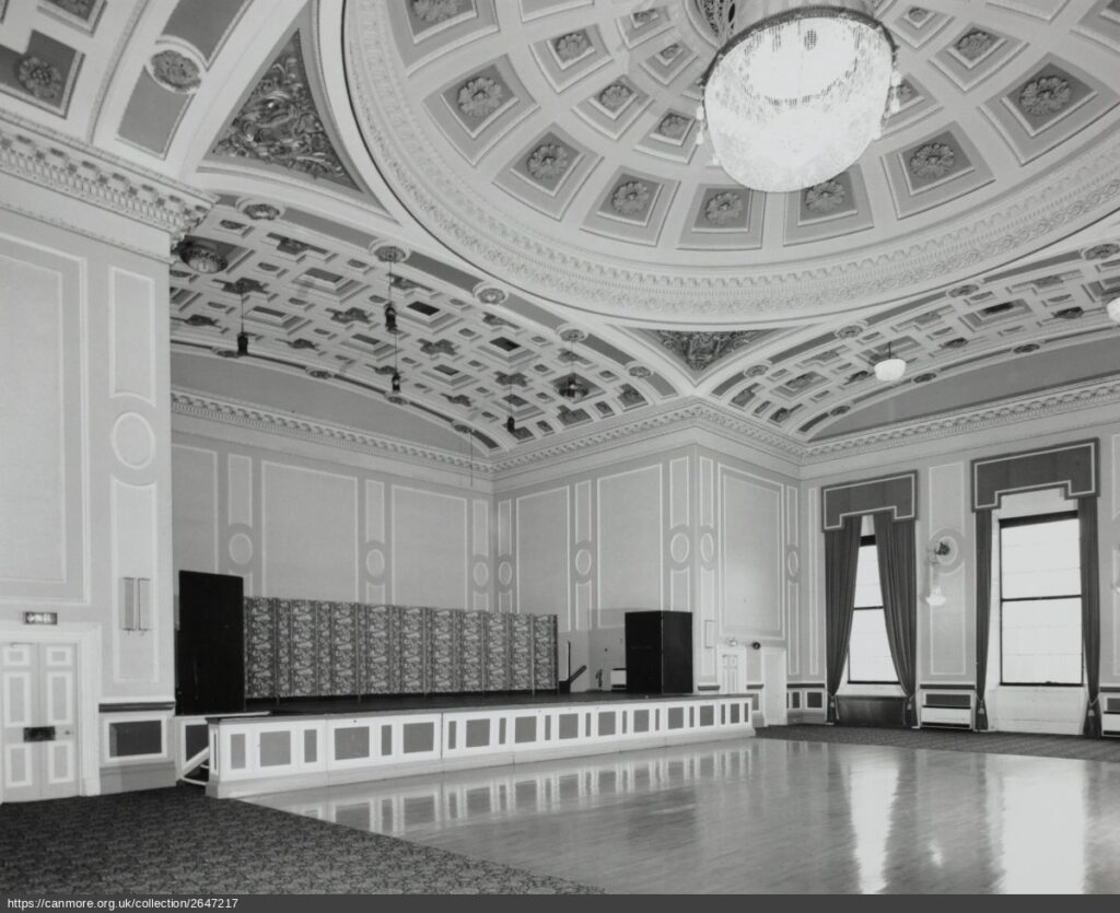 Photograph of interior of assembly rooms with hall and stage