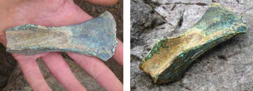Two photographs of flanged axehead. Left, picture in a hand and right, pictured on stone