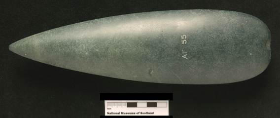 green axehead on black background