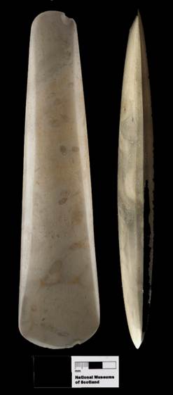 Photograph of axehead from front and side view on black background