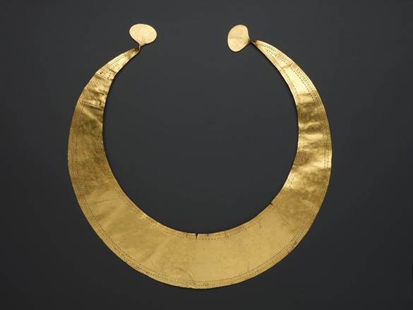 gold lunulae photographed on black background