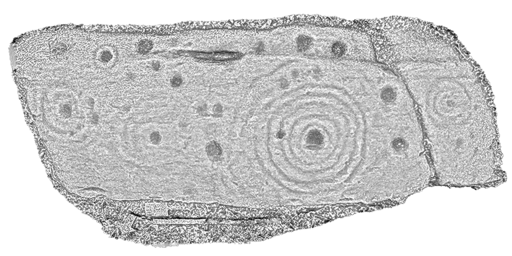 Greyscale image showing a rectangular carved stone with cupmarks and concentric circles. 