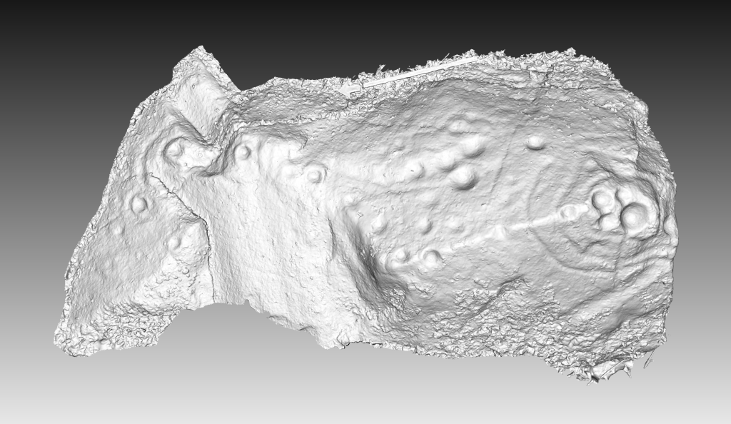 Greyscale 3d model of a long horizontal stone with clear cupmarks across it. 