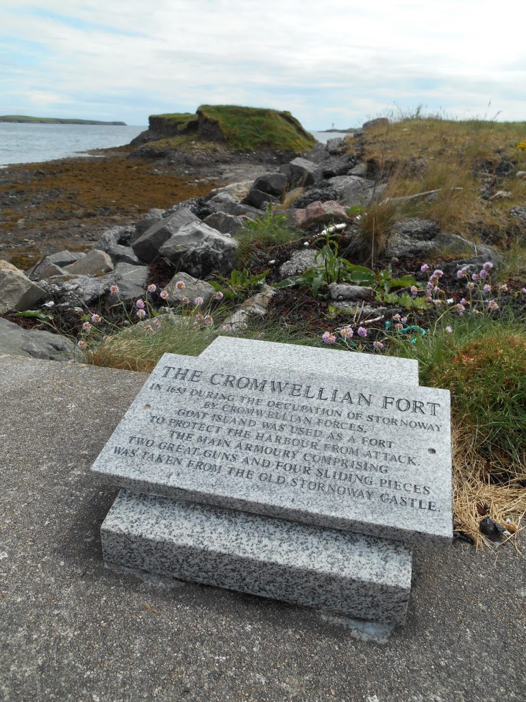 Stone plaque on a stone rectangular base which says The Cromwellian Fort with details about the site below. 